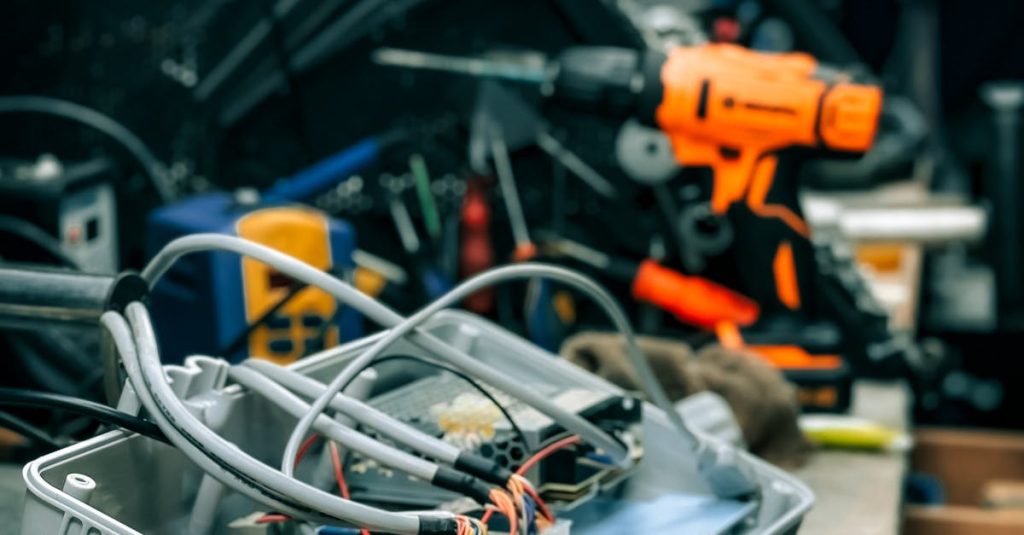 Workshop bench with electronic equipment and tools showcasing a repair environment.